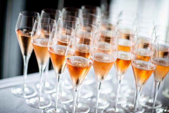 Multiple glasses of sparkling wine on a table.