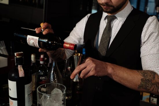 Bartender pouring liquor into a jigger