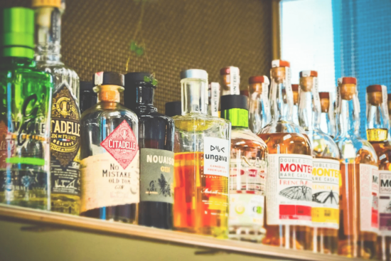 Assorted liquor bottles lined up on a shelf