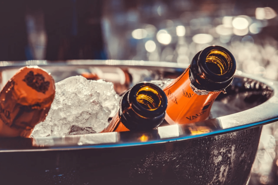 Champagne bottles chilling in an ice bucket.