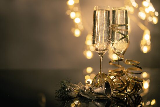 holiday champaign flutes and gold ribbon