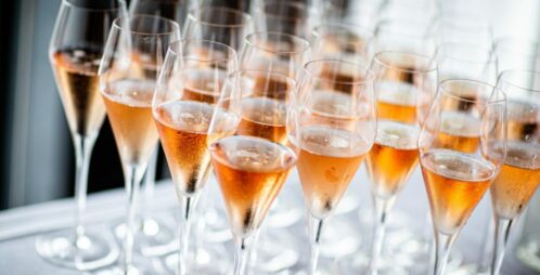 prepoured champagne flutes on bar