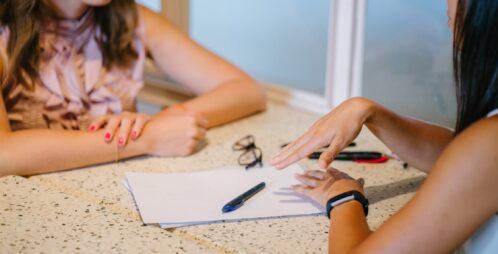 young women review paperwork