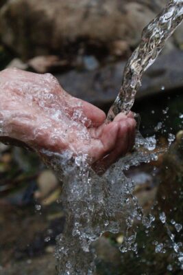 water pouring over hand