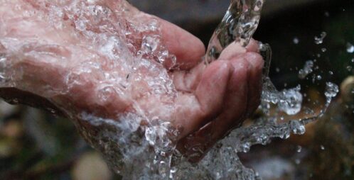 water pouring over hand