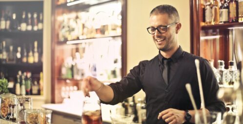 fancy bartender mixes cocktail