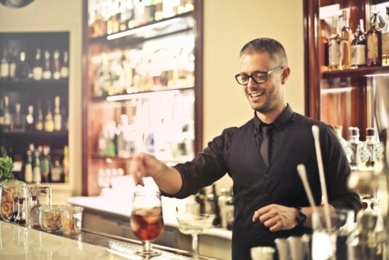 fancy bartender mixes cocktail