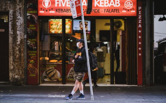 passerby waits at bus station