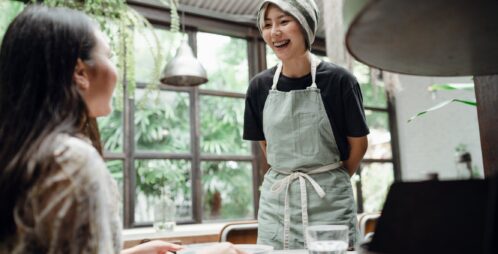 waitress laughs while taking customer order