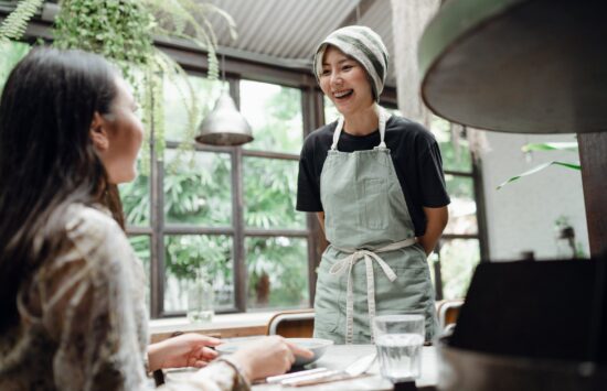 waitress laughs while taking customer order