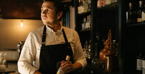 bartender holding bitters