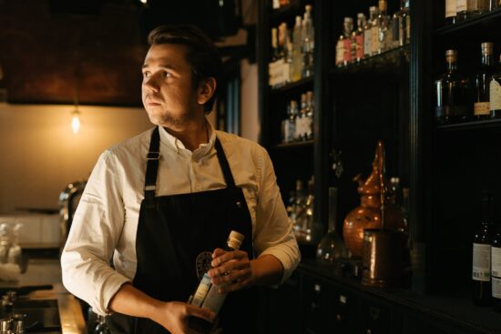 bartender holding bitters