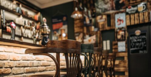 Wooden bar stools at brick bar