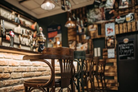 Wooden bar stools at brick bar