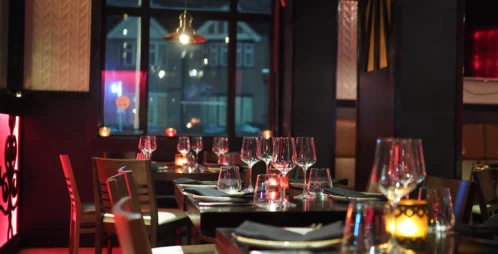 Fancy restaurant with wine glasses set at tables